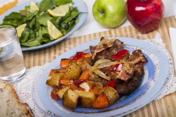 Baked meat with potatoes, and watercress salad Royalty Free Stock Photos