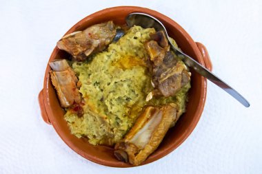 Typical Alentejo meal of pork ribs with migas clipart