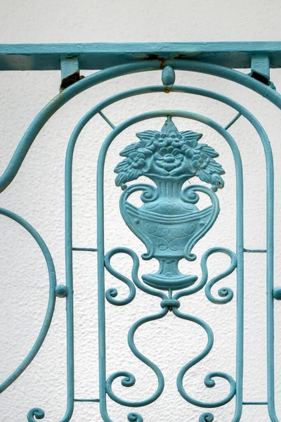 Classic vintage green iron gate detail closeup.