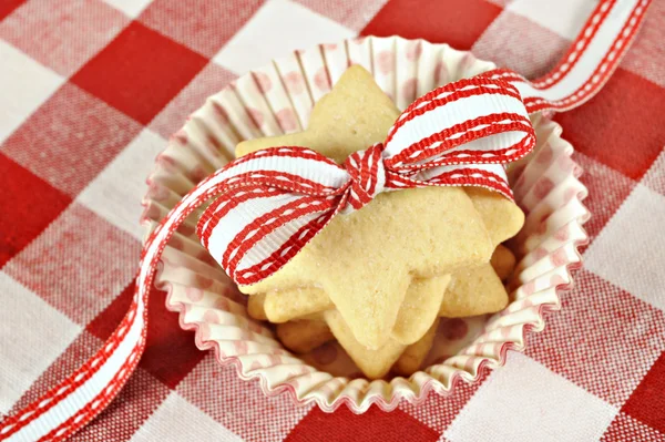 Star cookies with ribbon on checkered cloth — Stock Photo, Image