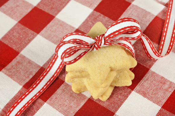 Star cookies with ribbon on checkered cloth — Stock Photo, Image
