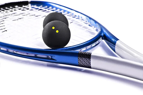 Raquette et balles de squash bleu et argent — Photo