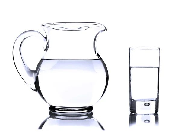 Glass jug and tumbler with water on white Stock Image