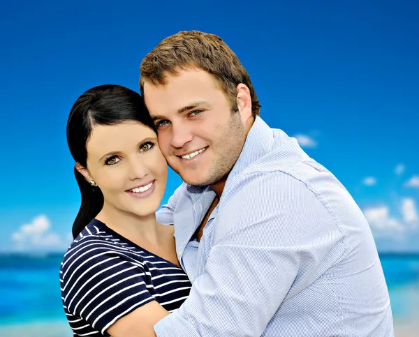 Beautiful young couple with sea in the background Stock Picture