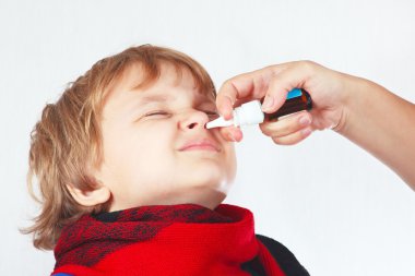 Little boy used a medical nasal spray in the nose