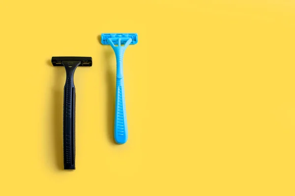 Two Plastic Razors Black Blue Yellow Background Male Female Disposable — Stock Photo, Image