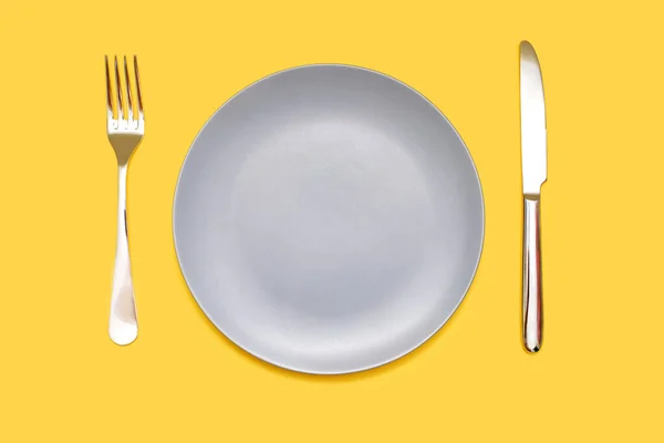 Γκρι Πιάτο Και Μαχαίρι Πιρούνι Κίτρινο Φόντο Κενό Γκρι Πιάτο — Φωτογραφία Αρχείου