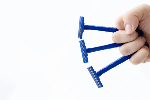 Three Disposable Razors Made Blue Plastic Man Hand White Background — Stockfoto