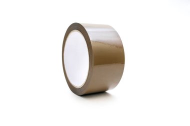 A roll of brown adhesive tape on a white background in the center of the image. A stationery item in the form of sticky tape for gluing paper or for a delivery service