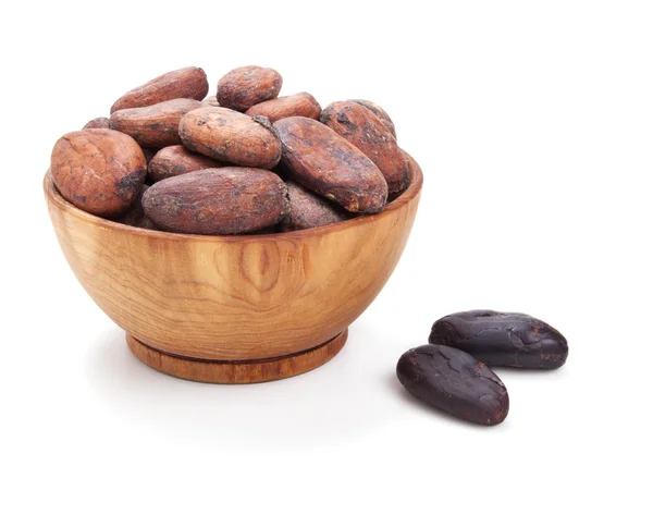 Wooden bowl full of cacao beans isolated on white — Stock Photo, Image