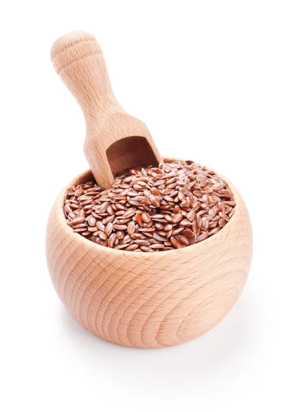 Wooden scoop in bowl full of flax seeds isolated on white — Stock Photo, Image