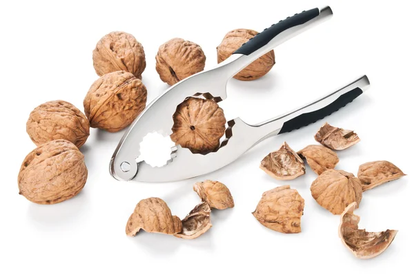 Walnuts and nutcracker isolated on white — Stock Photo, Image