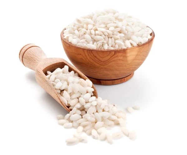 Arborio rice in a wooden bowl isolated on white — Stock Photo, Image