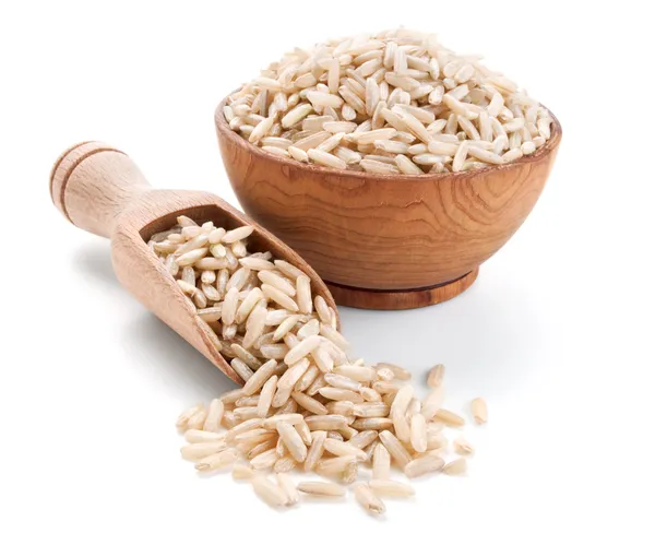 Brown rice in a wooden bowl isolated on white — Stock Photo, Image