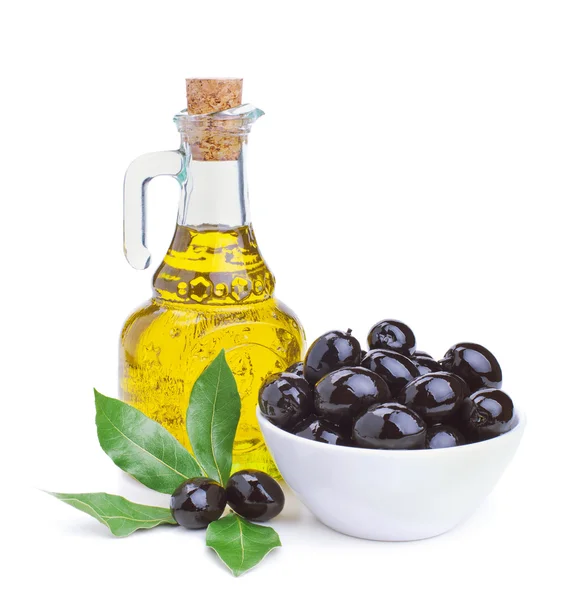 Olive oil and black olives with leaves — Stock Photo, Image