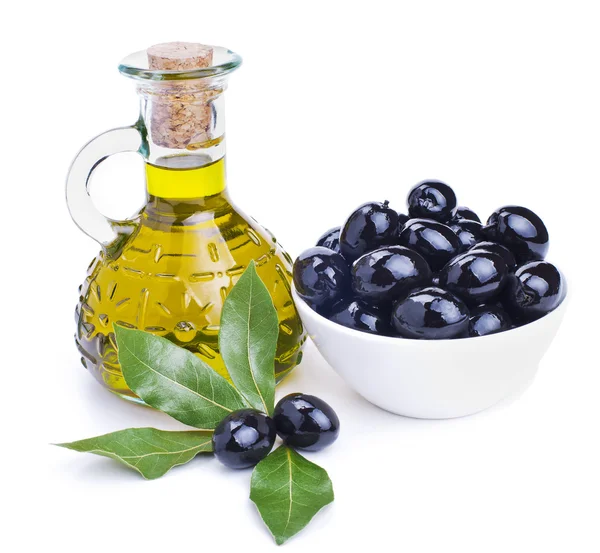 Olive oil and black olives with leaves — Stock Photo, Image