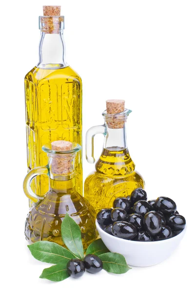 Bottles of olive oil and black olives with leaves — Stock Photo, Image