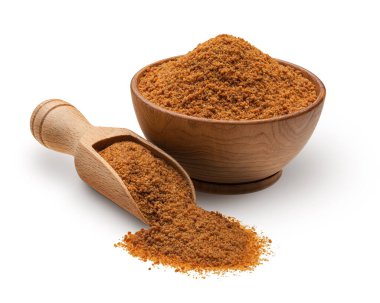 Wooden scoop and bowl full of palm sugar isolated on white background. Deep focus