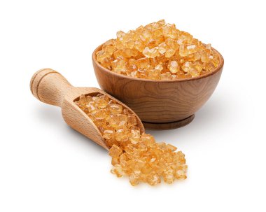 Wooden scoop and bowl full of large brown sugar crystals isolated on white background. Deep focus
