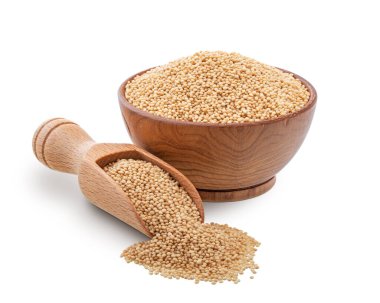 Wooden bowl and scoop full of amaranth seeds isolated on white background. Deep focus