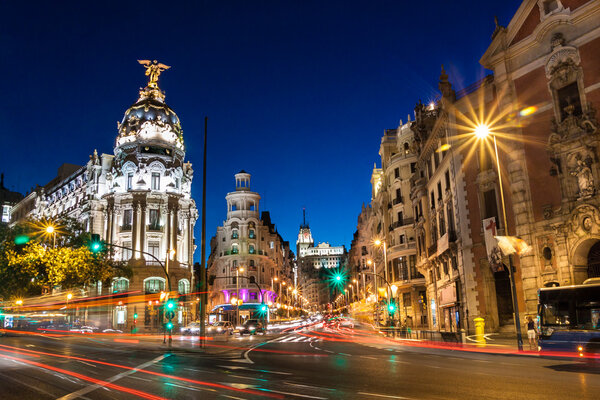 Rays of traffic lights on Gran via street, main shopping street in Madrid at night. Spain, Europe.