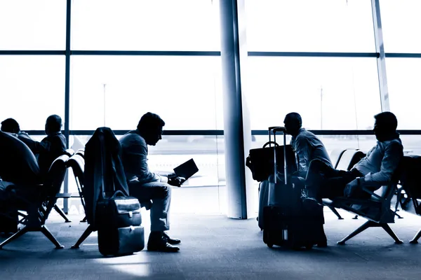 People traveling on airport silhouettes