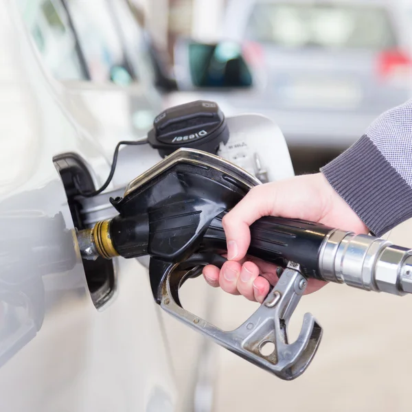 Petrol being pumped into a motor vehicle car. — Stock Photo, Image