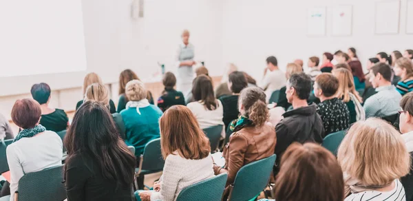 İş toplantısında kadın konuşmacı bir konuşma yapıyor. Konferans salonunda dinleyiciler. İş ve Girişimcilik Sempozyumu.