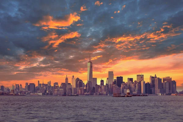 New York City Manhattan Downtown Skyline in der Abenddämmerung mit Wolkenkratzern beleuchtet über Hudson River Panorama. Dramatischer Sonnenuntergang. — Stockfoto