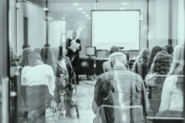 ビジネスと起業のシンポジウム 女性スピーカーがビジネスミーティングで話をする 会議室の観客 認識されていない聴衆の参加者の後面図 ホワイトスクリーン上のスペースのコピー — ストック写真