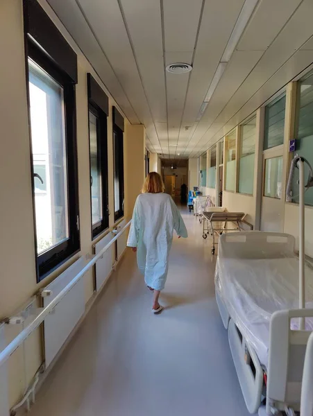 Female Patient Wearing Hospital Robe Walking Long Empty Hospital Hallway — Stockfoto