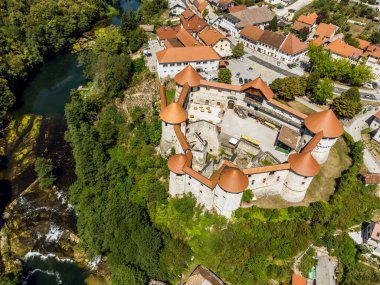 Aerial drone view of Medieval castle of Zuzemberk or Seisenburg or Sosenberch, positioned on terrace above the Krka River Canyon, Central Slovenia