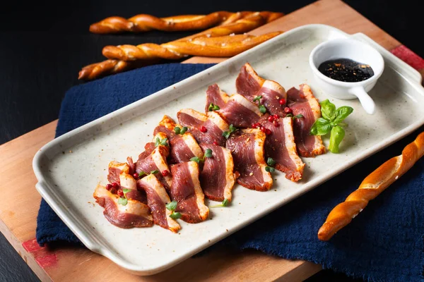 Food concept Spicy Smoked duck breast in ceramic plate on wooden board with copy space