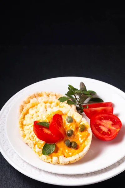 Food concept Organic Corn thin, Crackers in white plate on black slate stone plate with copy space