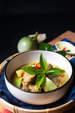 Asian Food concept Authentic Thai Green Curry beef and thai green eggplant on wooden board with copy space 