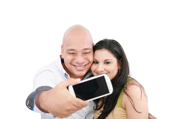 A young couple taking their picture on a mobile phone (focus on — Stock Photo, Image