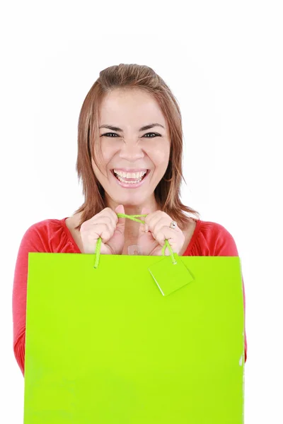 Junge Frau mit Einkaufstaschen vor weißem Hintergrund — Stockfoto