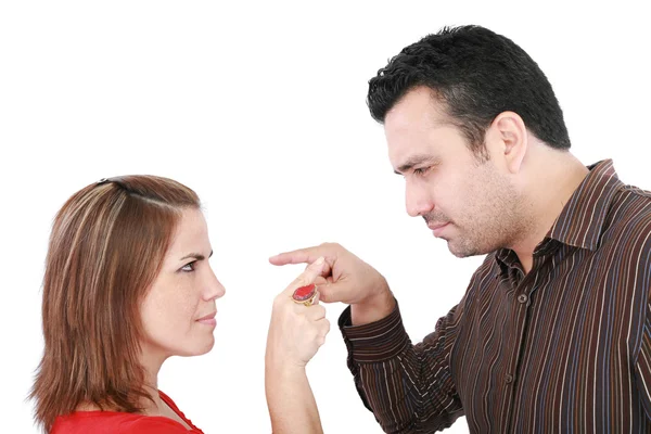 Young couple pointing at each other against a white background — Stock Photo, Image