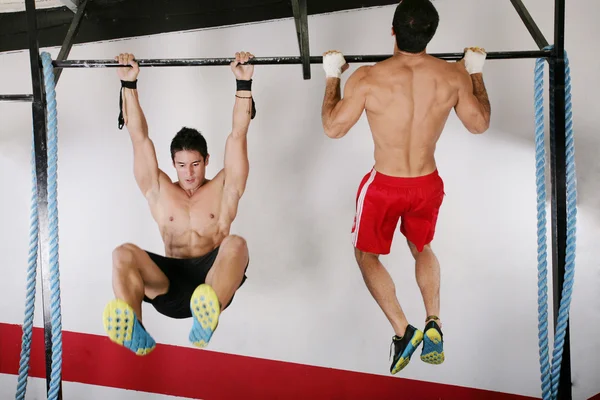 Athletic group executing exercise tightening on horizontal bar. — Stock Image Athletic group executing exercise tightening on horizontal bar. Stock Photo