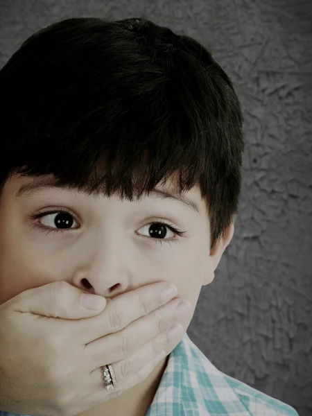 Scared 8 year old boy being abused or abducted by adult female. — Stock Photo, Image