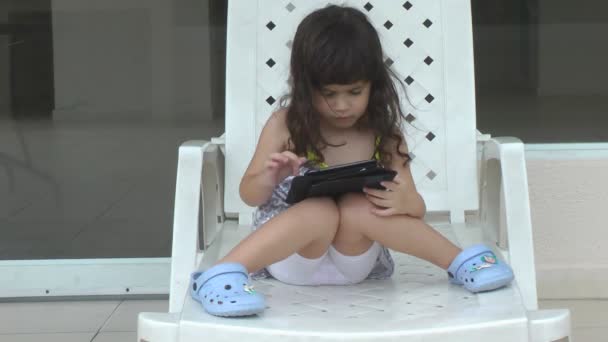 Little girl playing on computer tablet — Stock Video