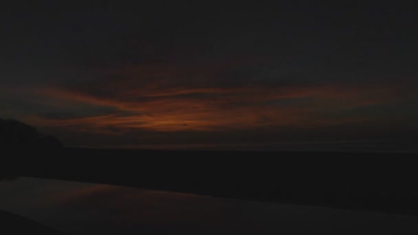 Un nuovo giorno albeggia sul fiume e sulla spiaggia- Timelapse filmato di una città sulla spiaggia come il cielo inizia ad alleggerire con l'arrivo di un nuovo giorno — Video Stock