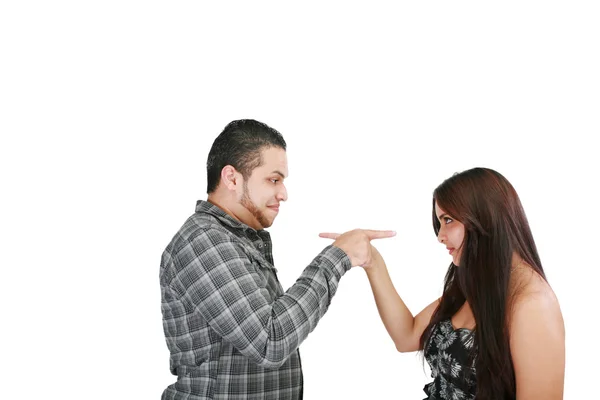 Young couple pointing at each other against a white background — Stock Photo, Image