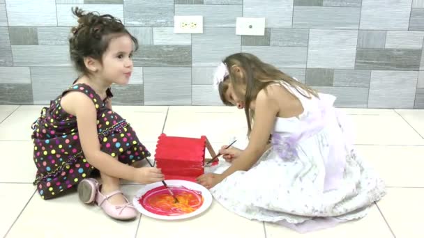 Two sisters on the floor enjoying painting — Stock Video