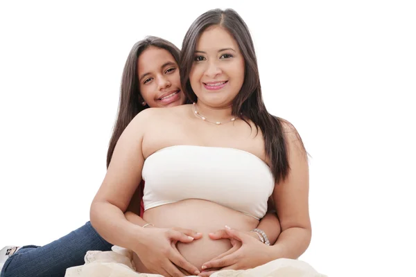 Pregnant woman and her daughter making a heart sign Stock Photo