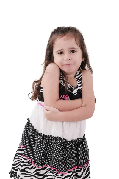 Angry little girl in dress with arms crossed on white background — Stock Photo, Image