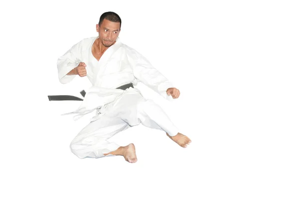 Black belt karate man jumping to give a high kick — Stock Photo, Image