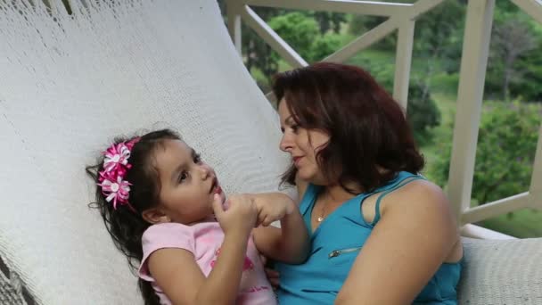 Mamá e hija acostadas en una hamaca — Vídeos de Stock