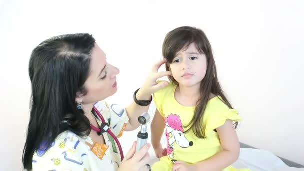 Attractive doctor examining patient's ears at the hospital — Stock Video