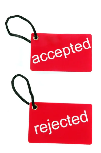Red paper tag labeled with accepted and rejected words — Stock Photo, Image